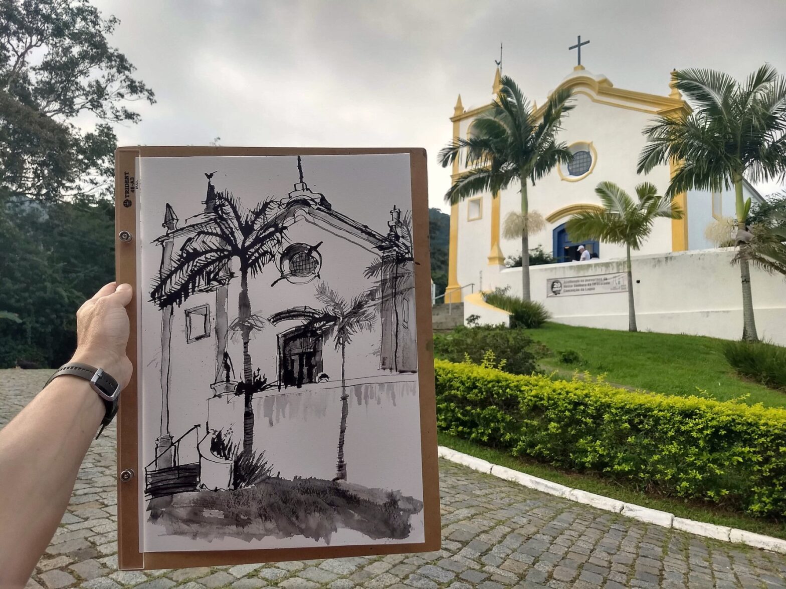 Desenho da igreja da Lagos em preto e branco em primeiro plano com a igreja ao fundo